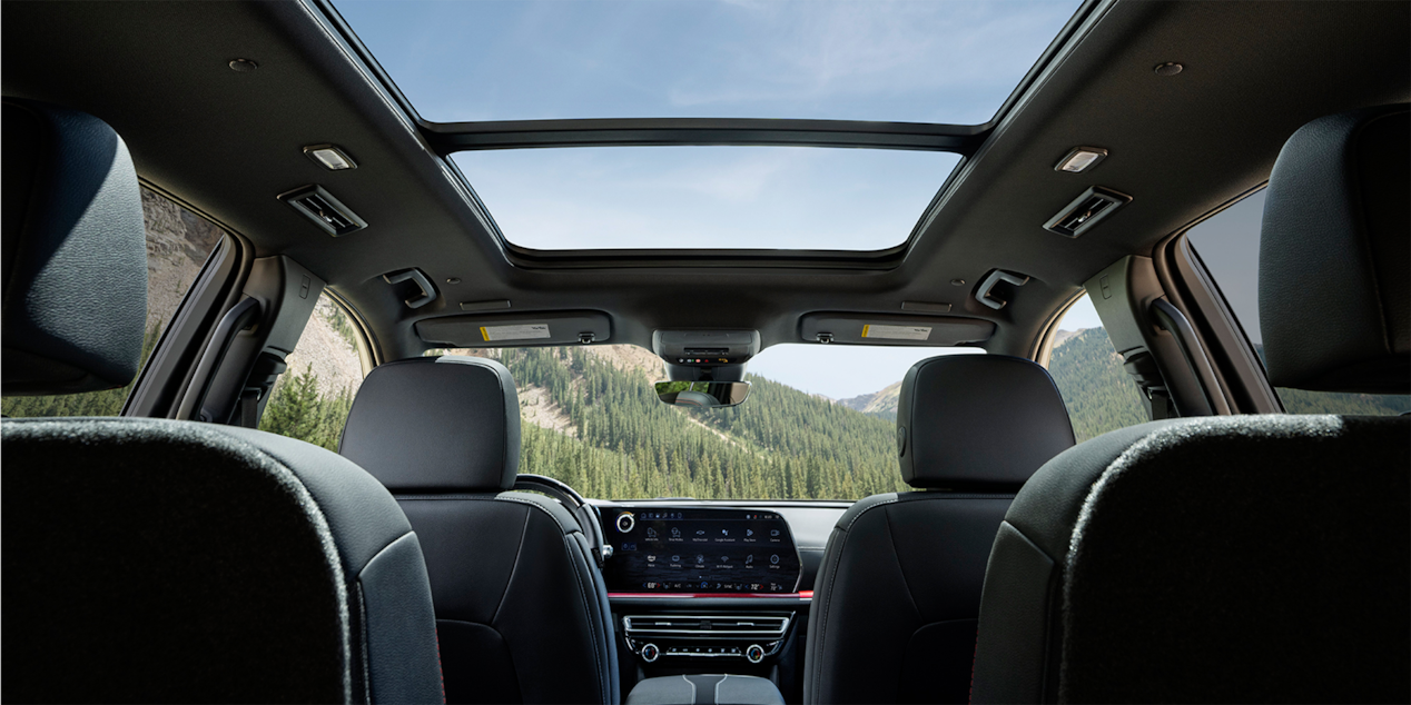 Rear passenger's view of the interiors of the 2025 Chevrolet Traverse SUV.