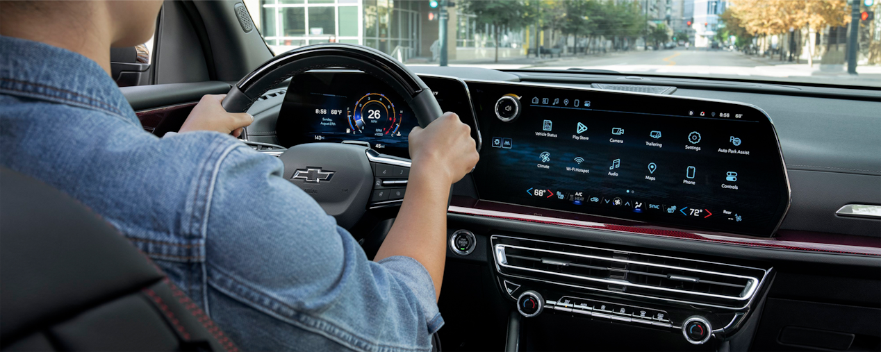 Back passenger's view of a driver on the driver's seat of the 2025 Chevrolet Traverse SUV.