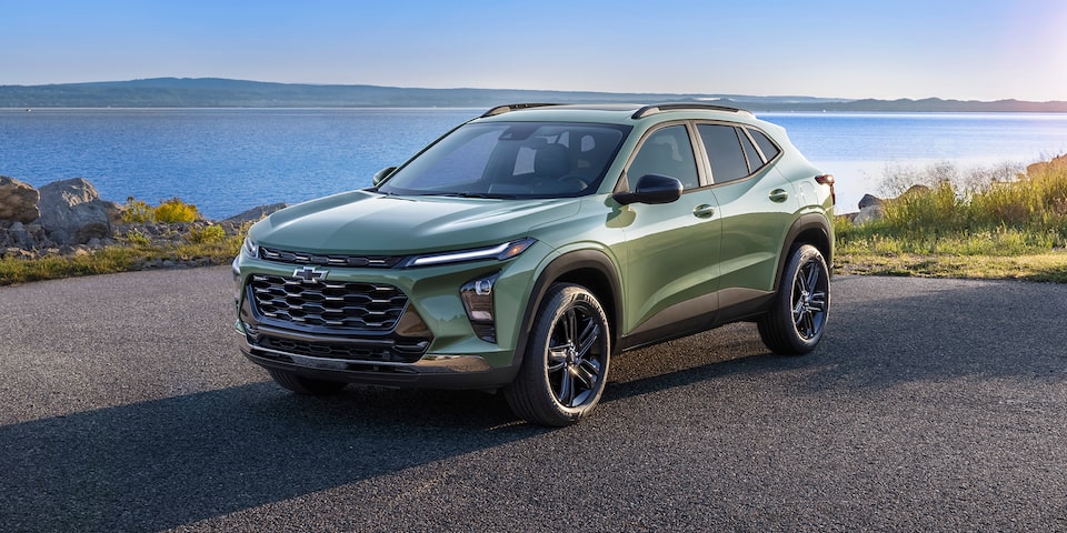 2025 Chevrolet Trax ACTIV parked by a large lake.