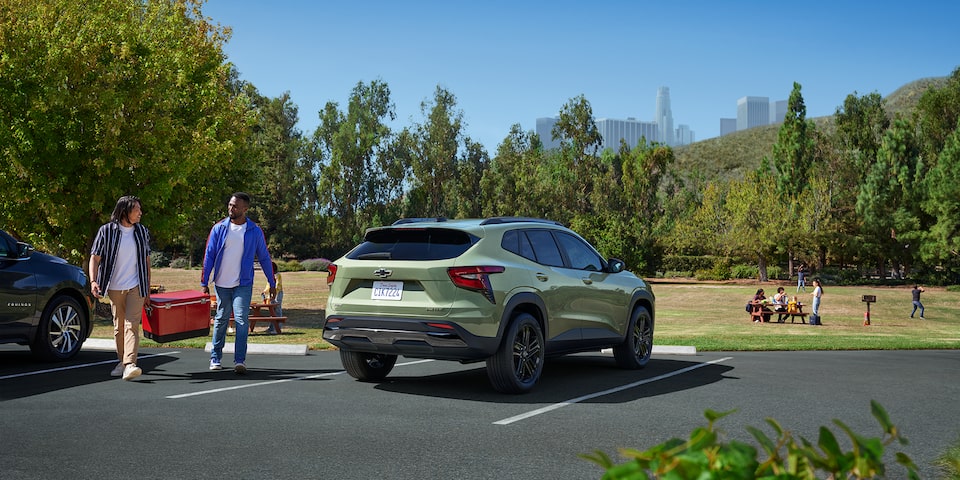 Scenic shot of the 2025 Chevrolet Trax ACTIV in a parking spot by a park.