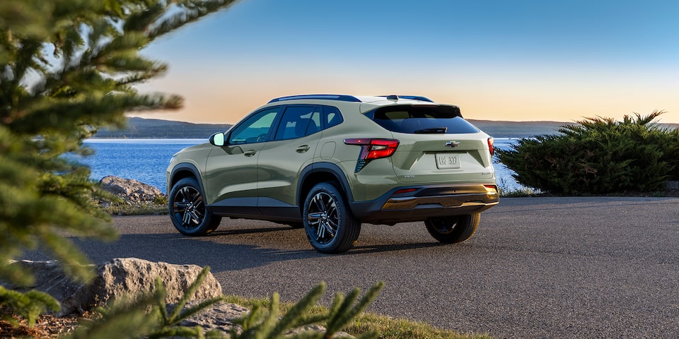 2025 Chevrolet Trax ACTIV parked facing a lake at sunset.