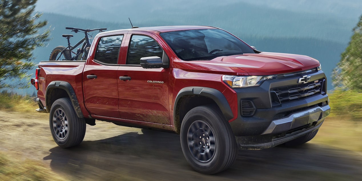 Side view of a red 2025 Chevrolet Colorado parked at a high altitude.