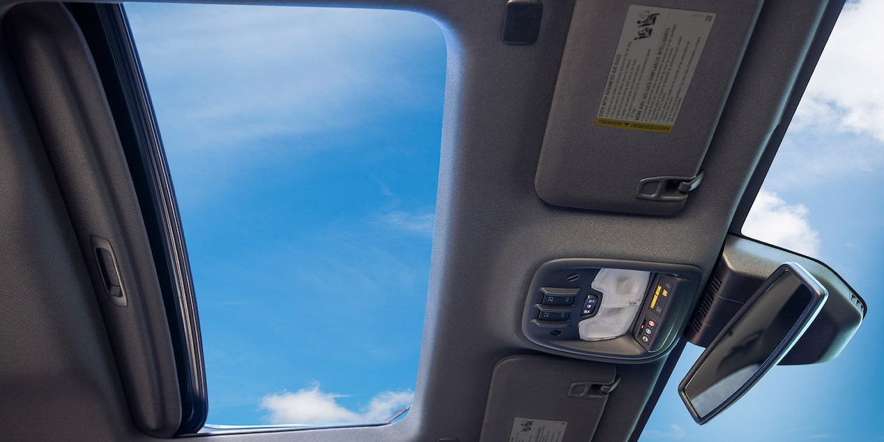 A beautiful view of the clear skies from the sunroof of the 2025 Chevrolet Colorado.
