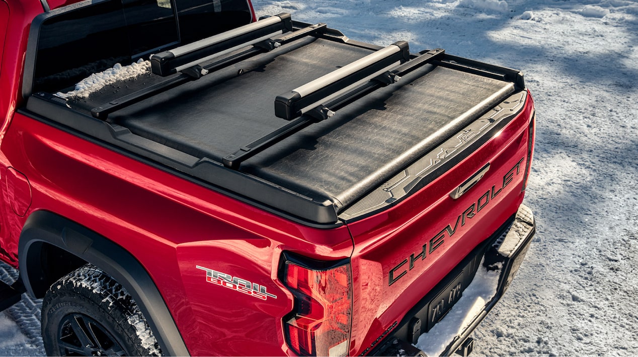Side view of a 2025 Chevrolet Colorado with its trunk being covered up.
