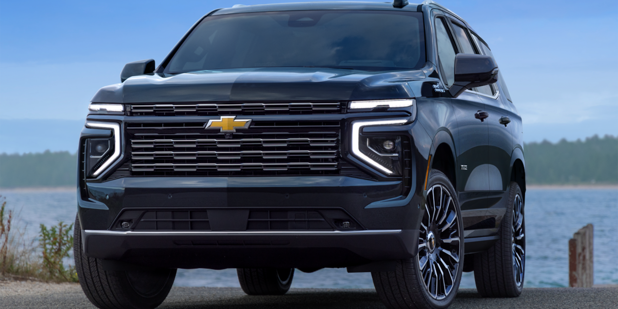 Front-side view of the 2025 Chevrolet Tahoe SUV parked by the lake.