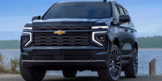 Front Three-Quarters View of the 2025 Chevrolet Tahoe SUV Parked Near a Lake