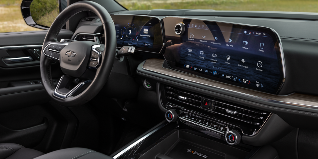 Front passenger's view of the steering wheel and infotainment system in the 2025 Chevrolet Tahoe SUV.