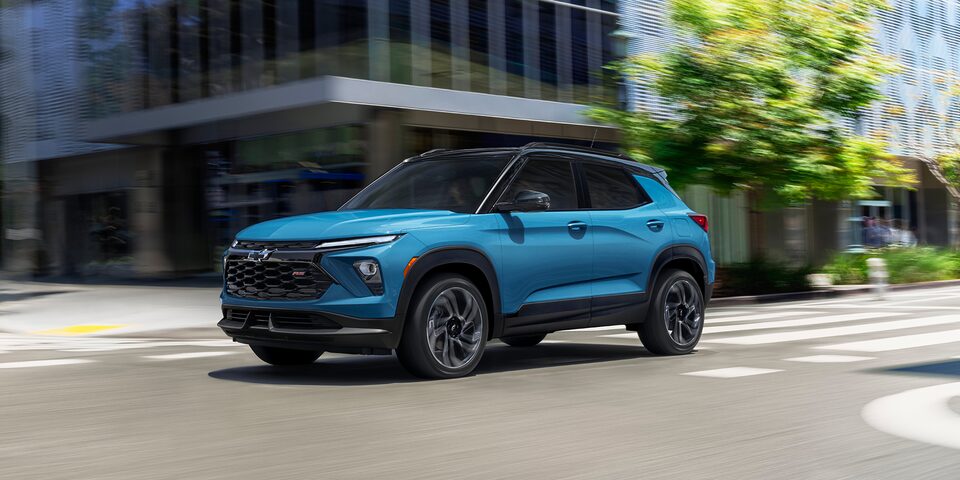 2025 Chevrolet Trailblazer driving through a city intersection.