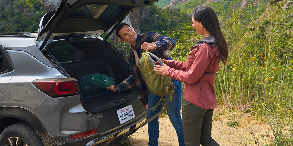 Unloading hiking gear from the trunk of the 2025 Chevrolet Trailblazer.