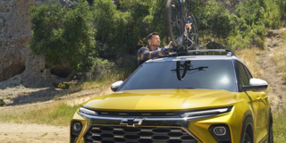 A Man Securing His Bike to the Roof of the 2025 Chevy Trailblazer