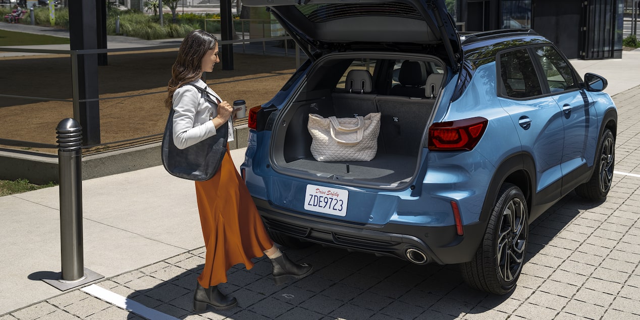 A person using the hands-free power liftgate in opening the trunk of the 2026 Chevrolet Trailblazer RS trim.