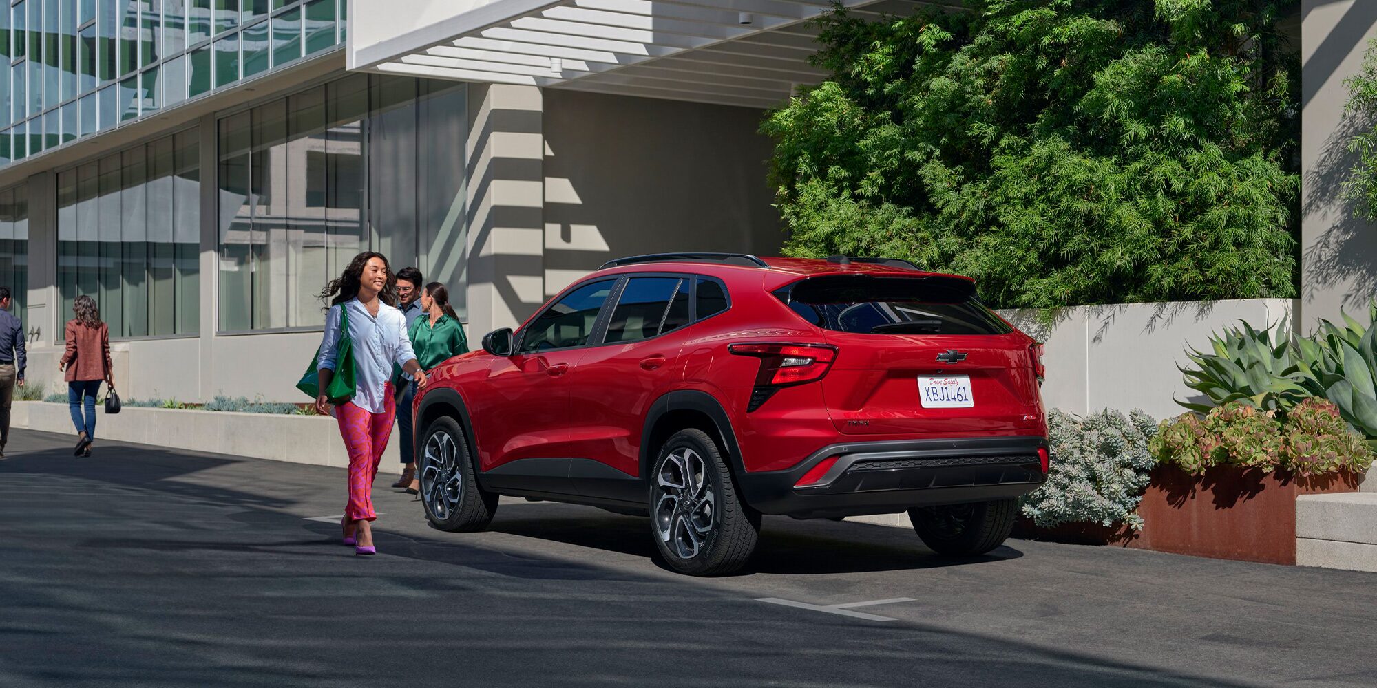 Back-side view of the 2026 Chevrolet Trax parked near a building.