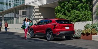 Back-side view of the 2026 Chevrolet Trax parked near a building.