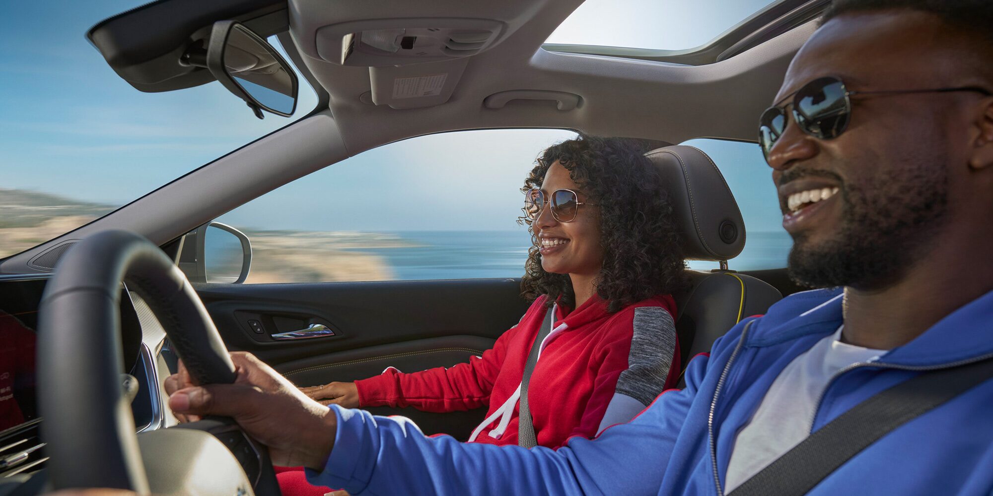Two people seated at the front row of the 2026 Chevrolet Trax.