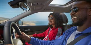 Two people seated at the front row of the 2026 Chevrolet Trax.