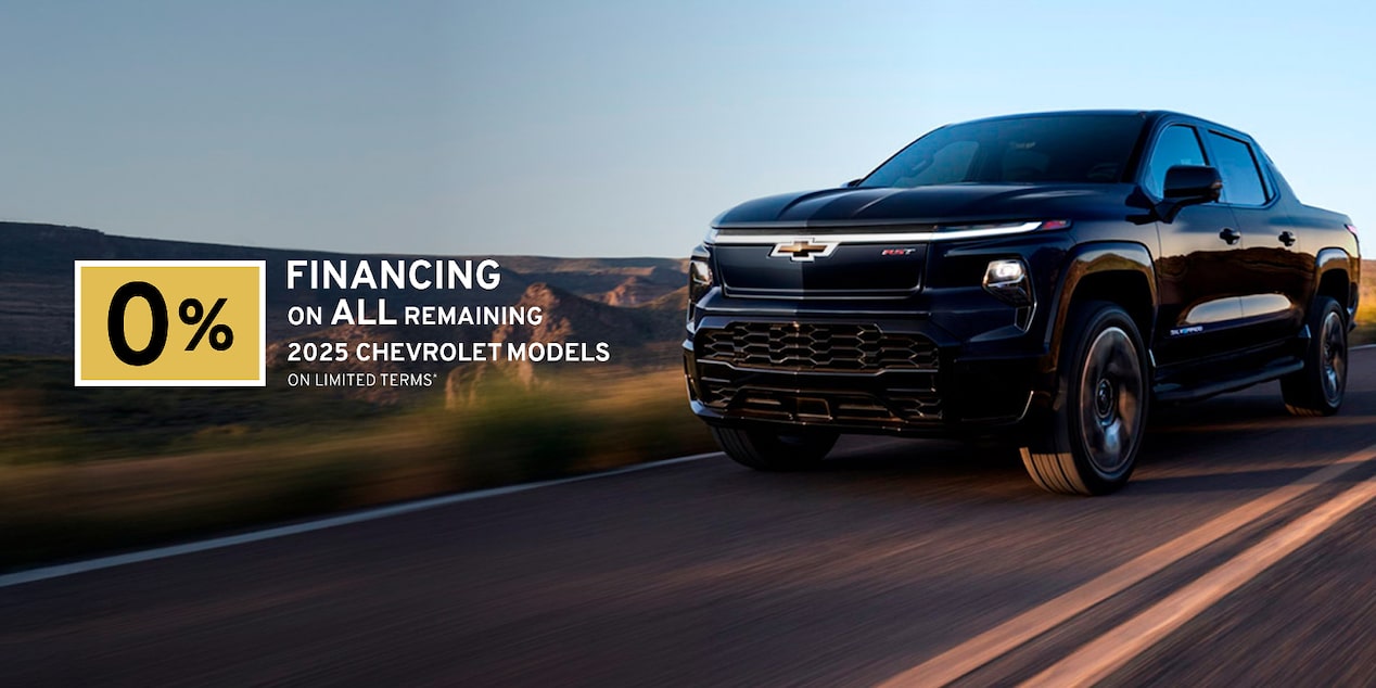Front-side view of a 2025 Chevrolet Silverado EV driving down the road.
