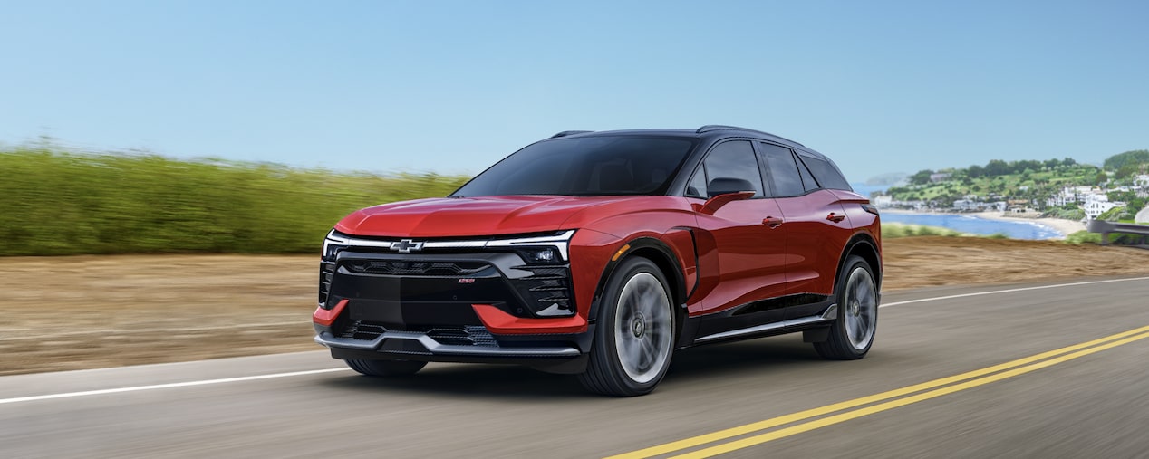 2026 Chevrolet Blazer EV driving down a road along the coast.