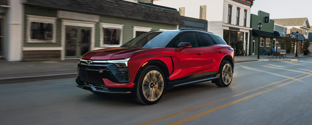 Side view of the 2026 Chevrolet Blazer EV driving in town.