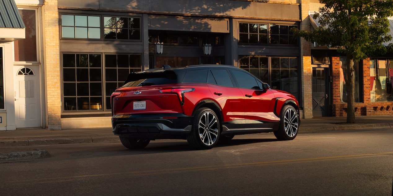 2026 Chevrolet Blazer EV driving past a building.