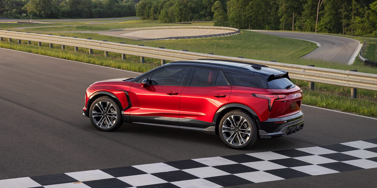 Side view of the 2026 Chevrolet Blazer EV parked near the finish line of a racetrack.