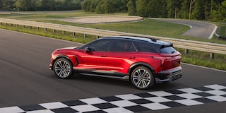 Side view of the 2026 Chevrolet Blazer EV parked near the finish line of a racetrack.