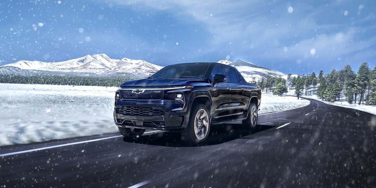 Chevrolet Silverado EV driving on a highway in winter.