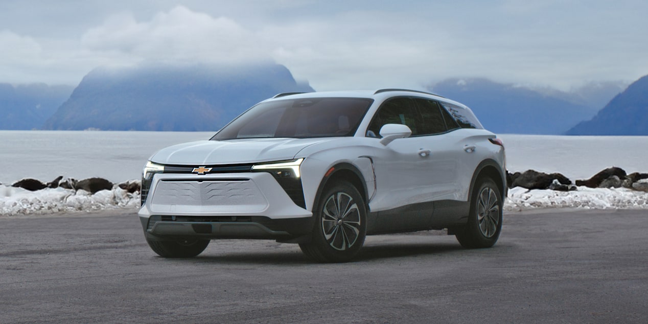 Chevrolet Blazer EV parked by a lake in winter.