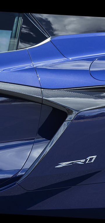 Vue latérale de l’emblème d’une Chevrolet Corvette ZR1 2025 bleue. 