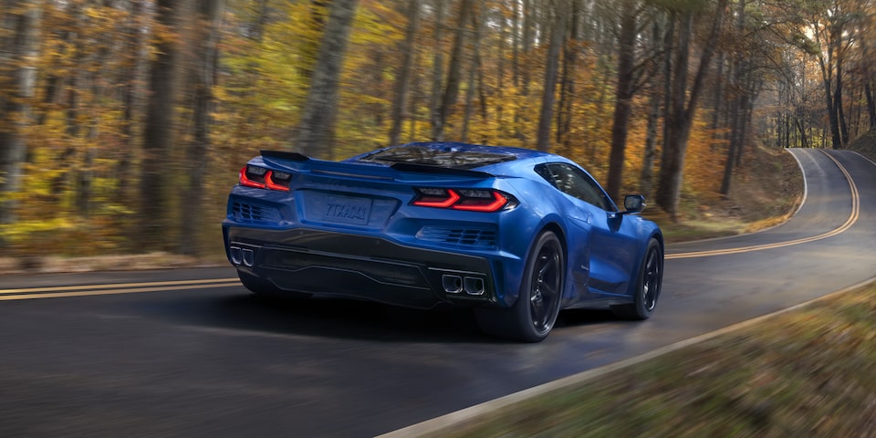 Riptide Blue Corvette E-Ray driving along a forest road