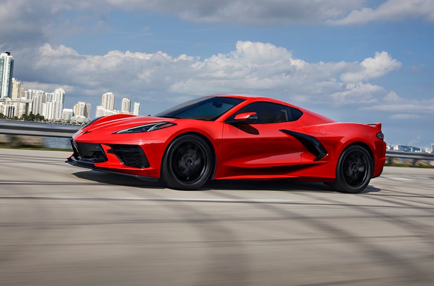Red Corvette Stingray Driving on City Highway