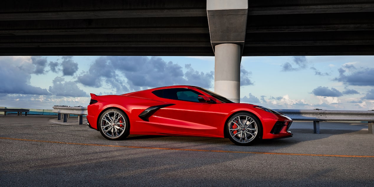 Red Corvette Stingray under bridge