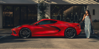 Side profile shot of a red Corvette Stingray parked on the street