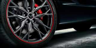 Close up of the20-spoke black forged aluminium wheel with red stripe