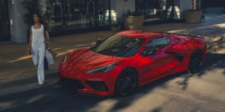 Torch Red Corvette Stingray driving on road