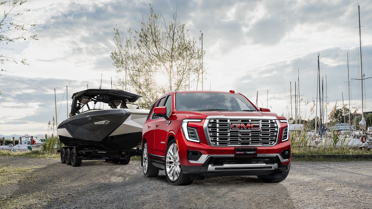Image of red Yukon Denali towing a boat