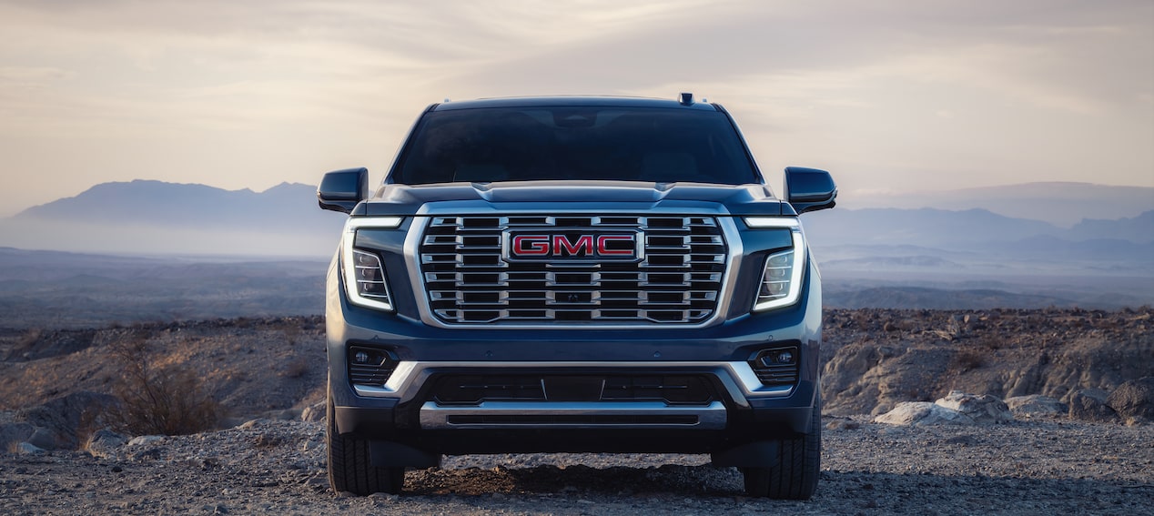 Front grille of Yukon Denali in canyon landscape