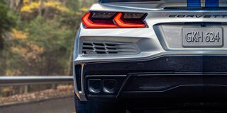 Rear End View of the 2024 Chevrolet Corvette E-Ray Driving Through a Forest